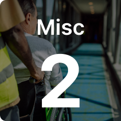 A person in a wheelchair is pushed down a bright, windowed corridor, with the text "Misc 2" overlaid on the image.