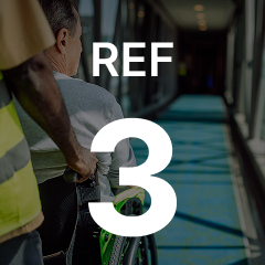 A person in a wheelchair is being pushed through a corridor. The text "REF 3" is overlaid on the image.
