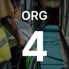 Person in a wheelchair being assisted down a corridor. Large text overlay reads "ORG 4."