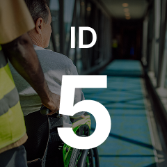 Person in a wheelchair being assisted down a corridor. Large "ID 5" text overlays the image.