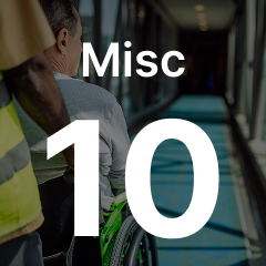 Person in a wheelchair being assisted down a corridor, with "Misc 10" overlaid on the image.