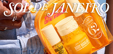 A clear bag with Sol de Janeiro body care products, including Brazilian Bum Bum Cream, held against a denim background.