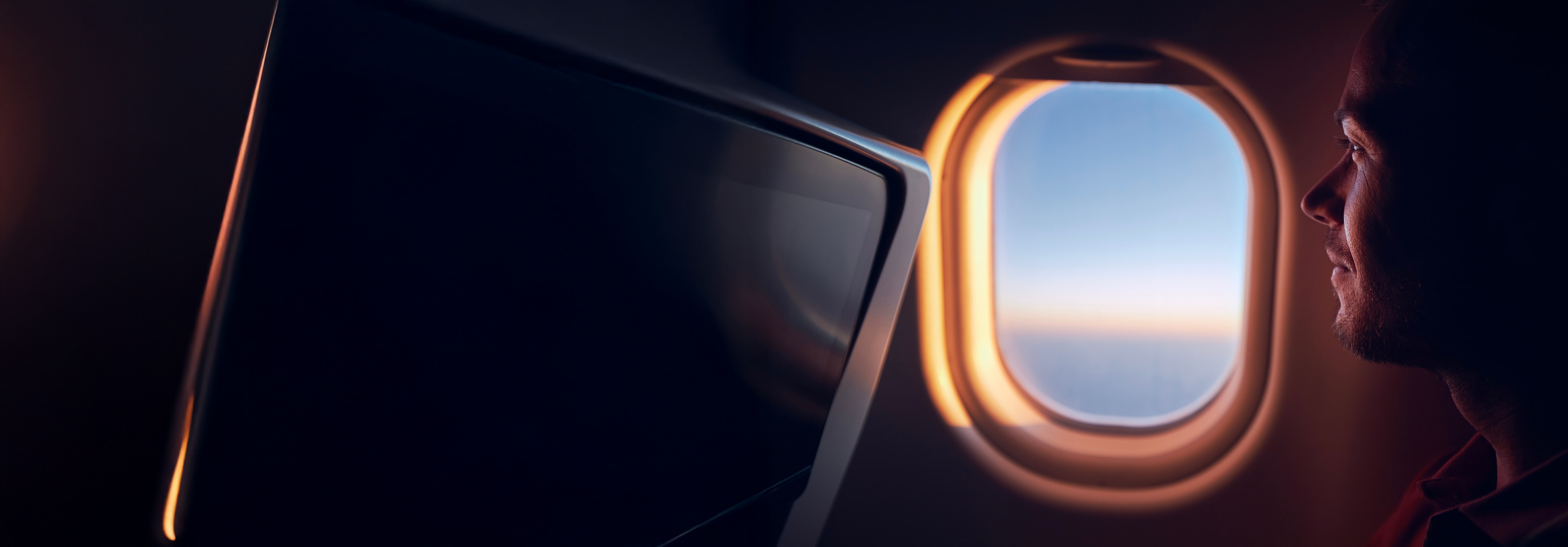 Man looking out of window airplane