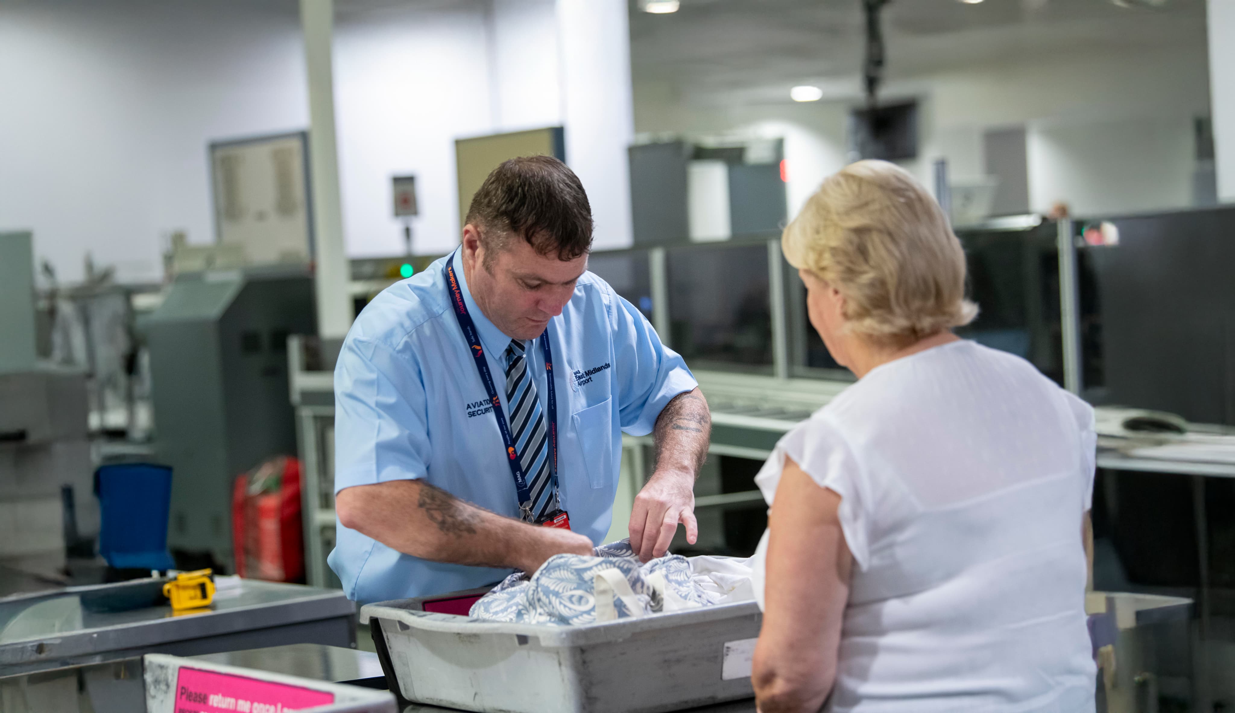 Security officer checking luggage in tray