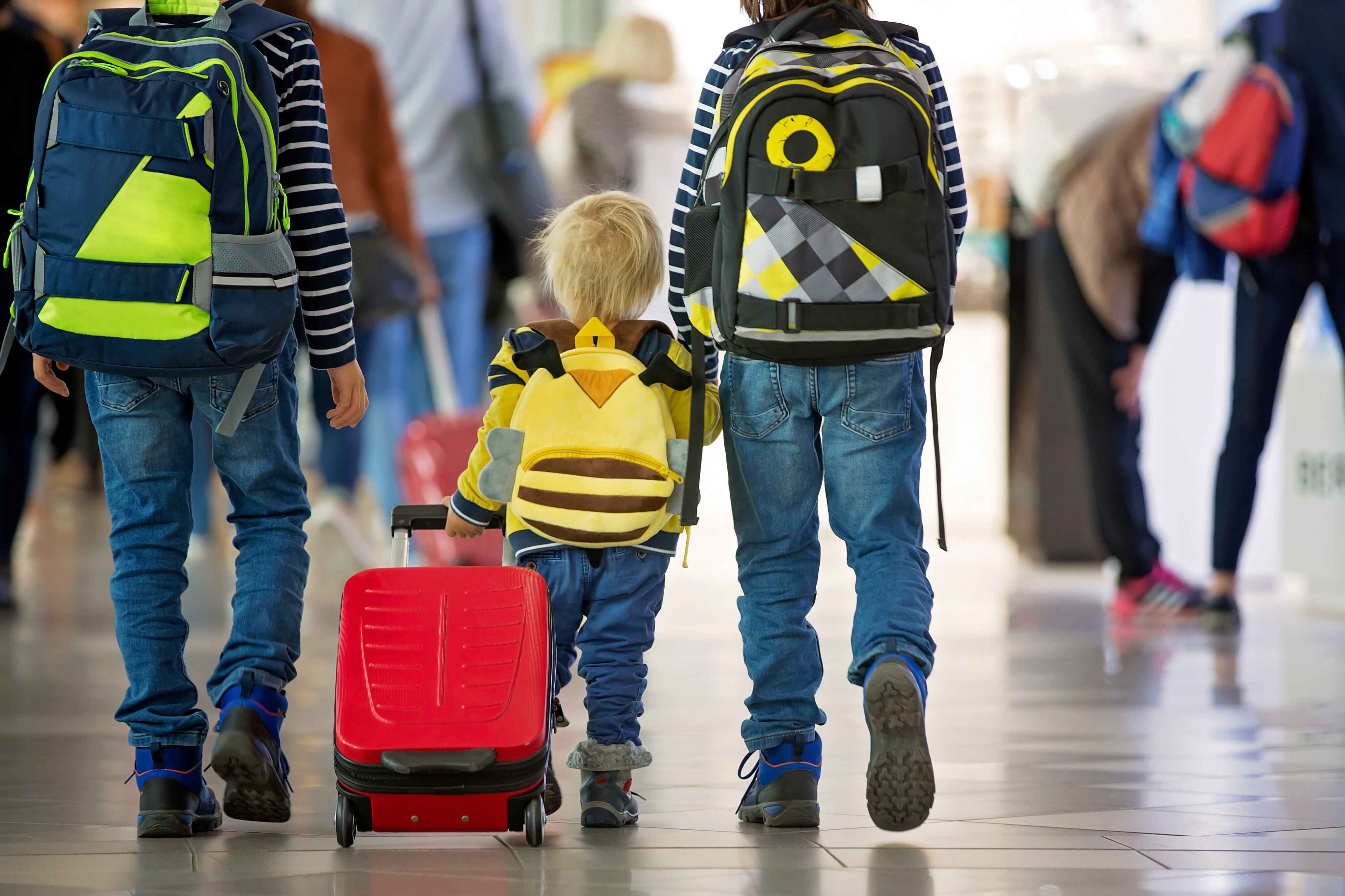 image of a family walking through an airport