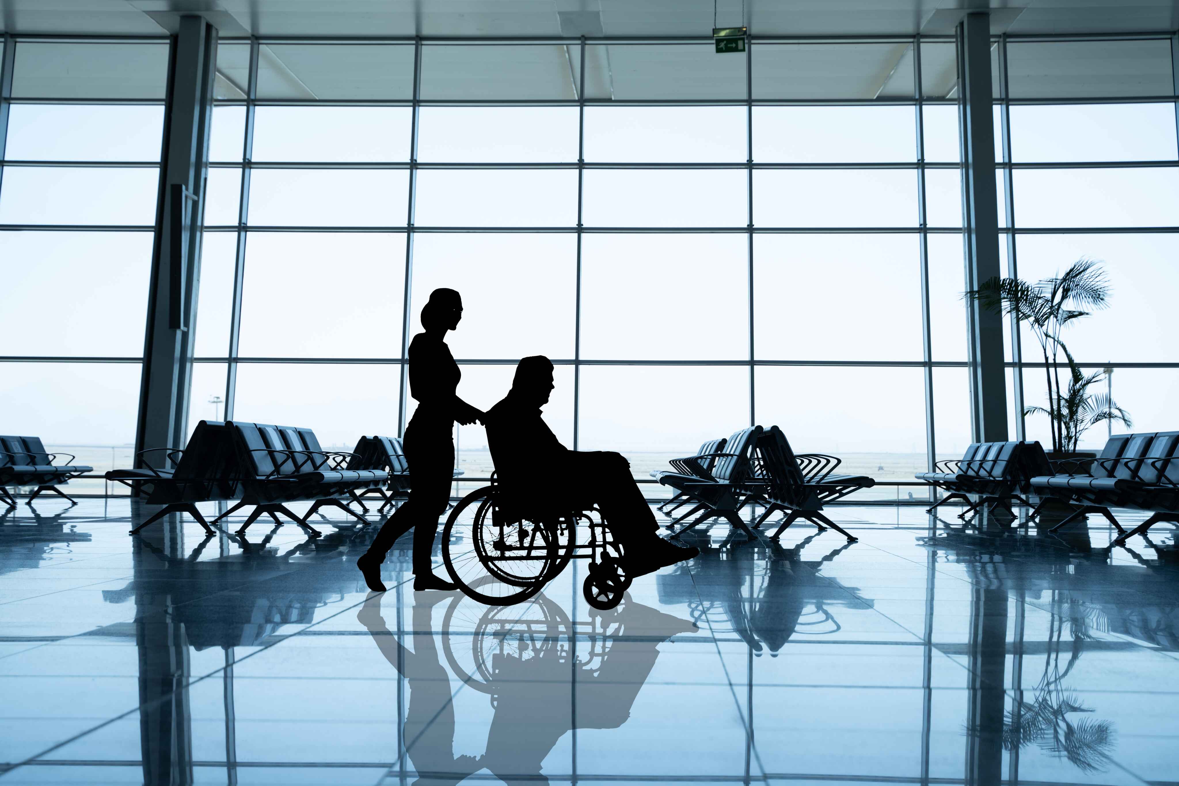 person being pushed through airiport in wheelchair