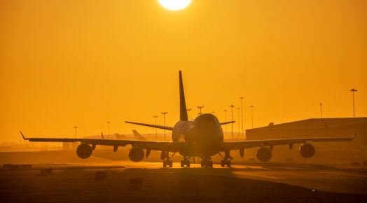 Cargo plane landing at sunset