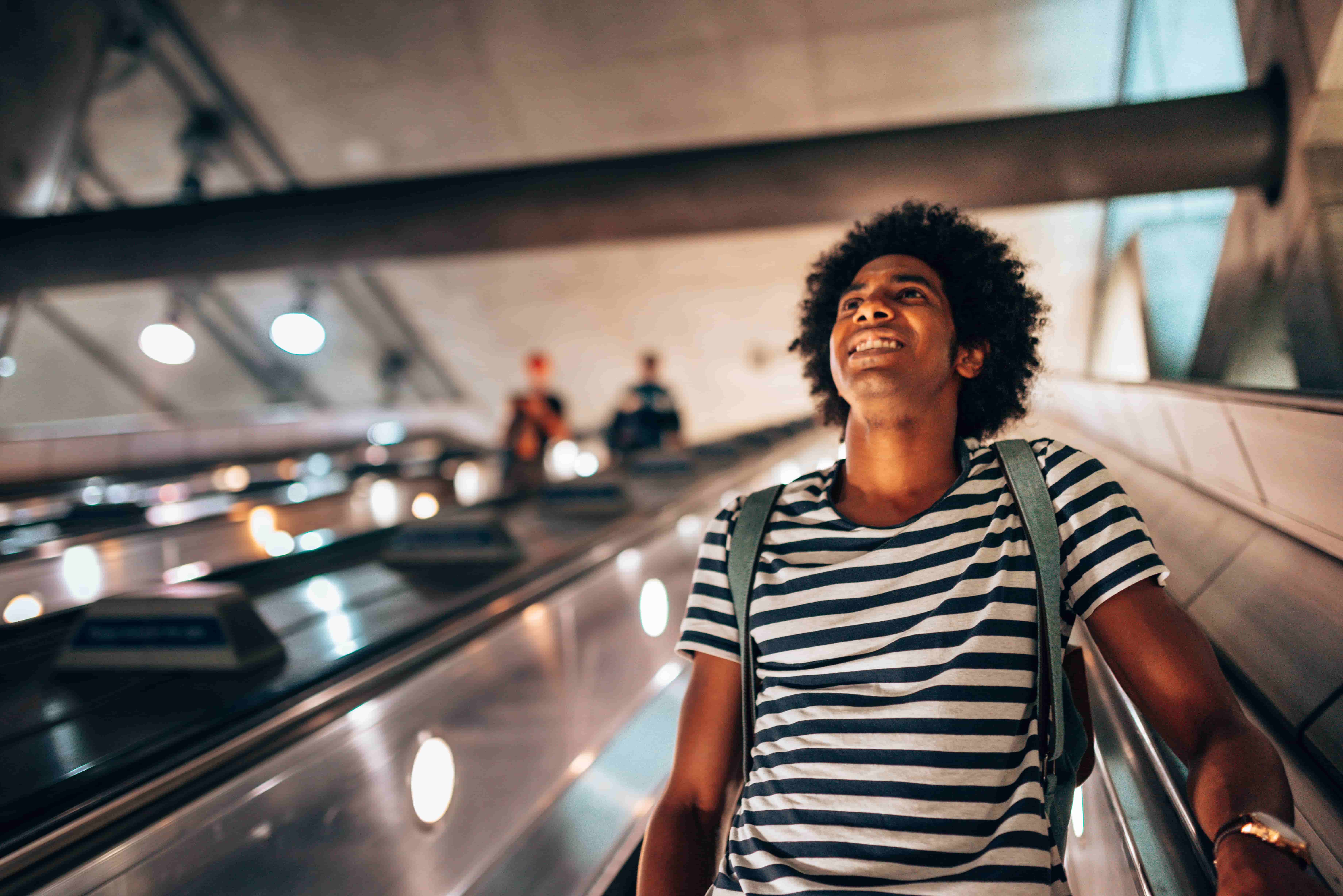 Man coming down escalator